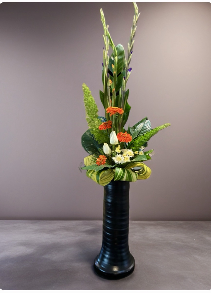 A modern arrangement in a matte black vase